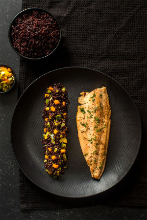 Black rice with vegetables and trout